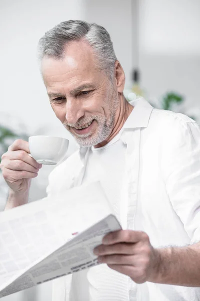 Business man having coffee and reading newspaper — Stock Photo