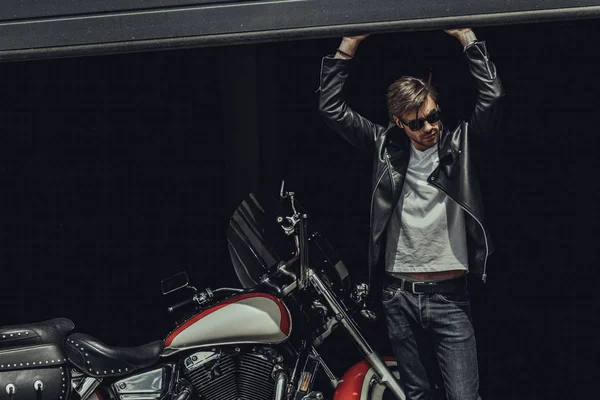Stylish man with motorbike — Stock Photo