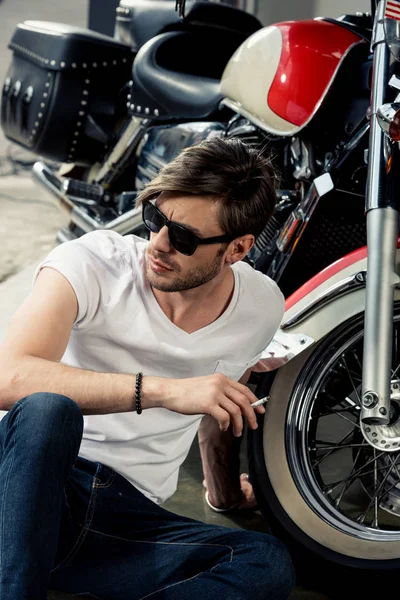 Stylish man with motorbike — Stock Photo