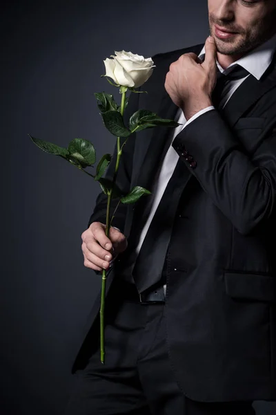 Homem de terno segurando rosa branca — Fotografia de Stock