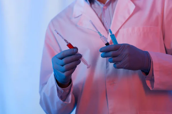 Scientist holding syringes — Stock Photo