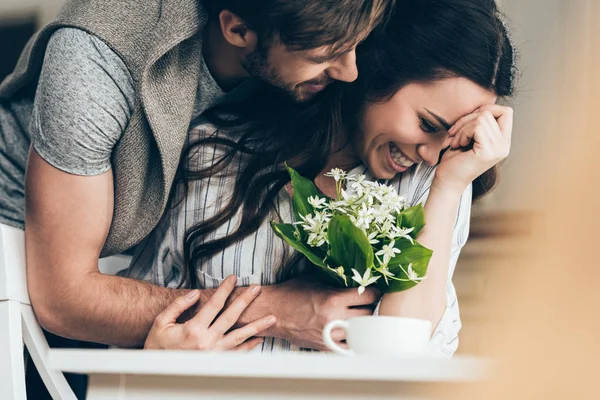 Young couple with flowers — Stock Photo