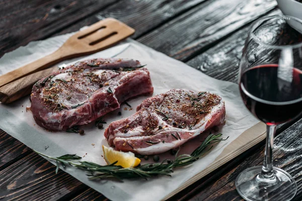 Raw ribeye steaks with spices — Stock Photo