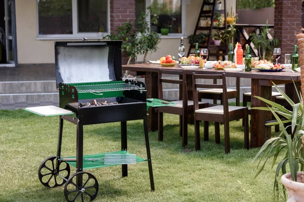 Grill on green lawn — Stock Photo