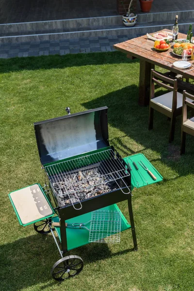 Grill on green lawn — Stock Photo