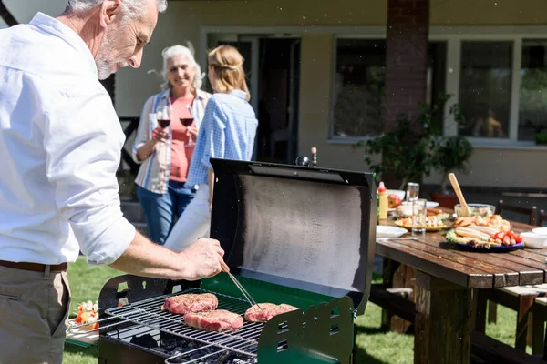 Man grilling meat — Stock Photo