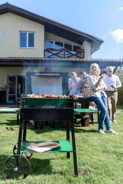 Family spend time together at barbecue — Stock Photo
