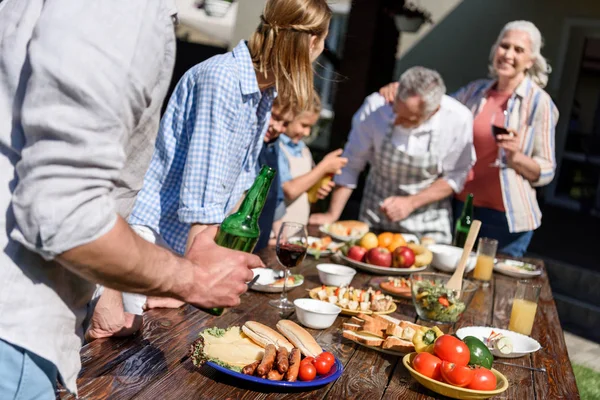 Happy family having picnic on patio — Stock Photo