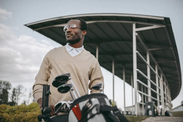 African american golfer with golf clubs — Stock Photo