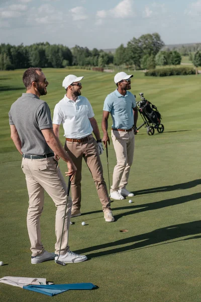 Multiethnic golf players looking away — Stock Photo