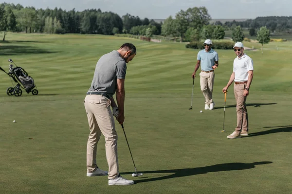 Young friends playing golf — Stock Photo