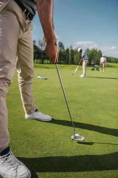 Golfer getting ready to hit a ball — Stock Photo