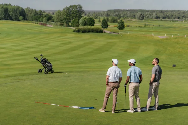 Professional players standing on golf pitch — Stock Photo