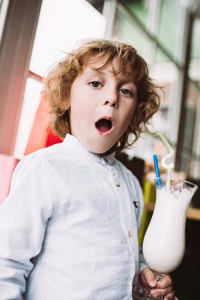 Little boy holding milkshake — Stock Photo