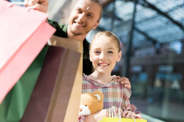 Padre e hija sosteniendo bolsas de compras - foto de stock