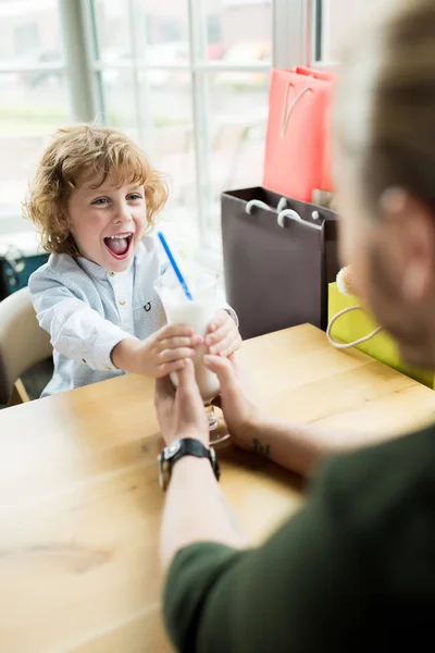 Boy holding milkshake — Stock Photo