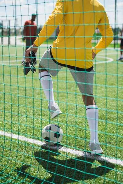 Goalkeeper with ball at pitch — Stock Photo