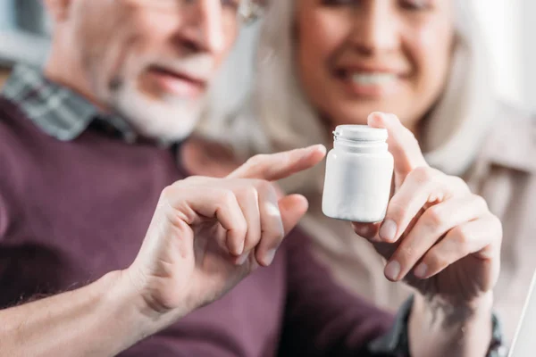 Pareja con frasco de pastillas - foto de stock