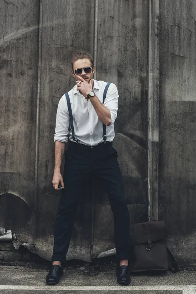 Stylish young man smoking — Stock Photo