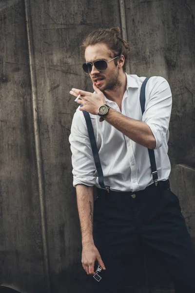 Stylish young man smoking — Stock Photo