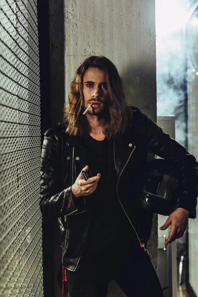 Stylish long haired man with cigarette — Stock Photo