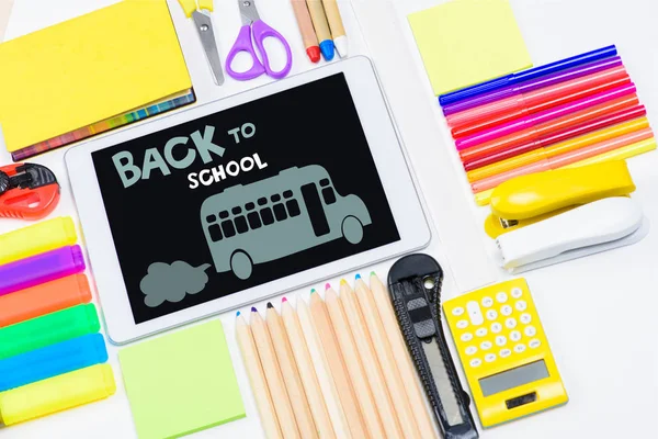Tablet and school supplies — Stock Photo