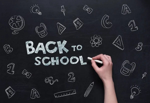 Back to school lettering on blackboard — Stock Photo