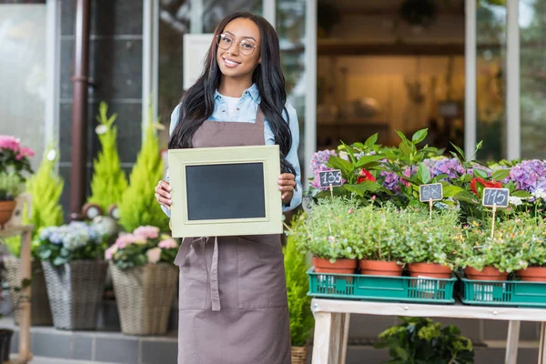 African american florist with blank sign — Stock Photo