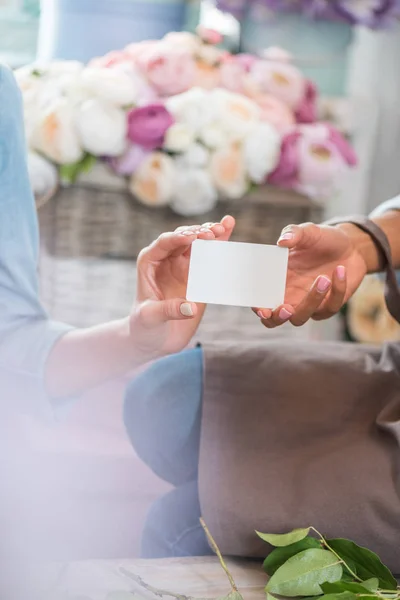 Florists holding blank card — Stock Photo