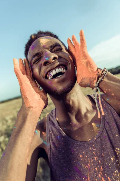 African american man at holi festival — Stock Photo