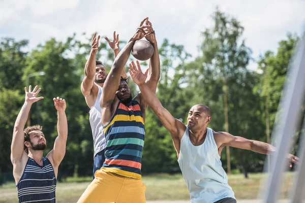 Hommes multiculturels jouant au football — Photo de stock