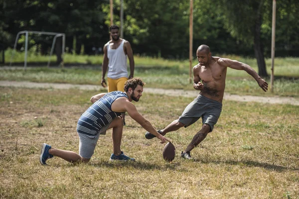 Multicultural men playing football — Stock Photo