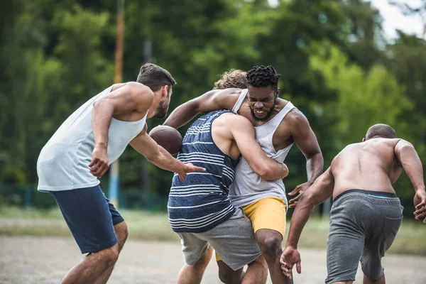 Hommes multiculturels jouant au football — Photo de stock