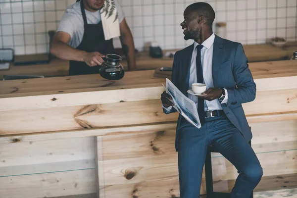 Businessman with newspaper on coffee break — Stock Photo