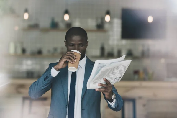 Uomo d'affari con caffè leggendo giornale — Foto stock
