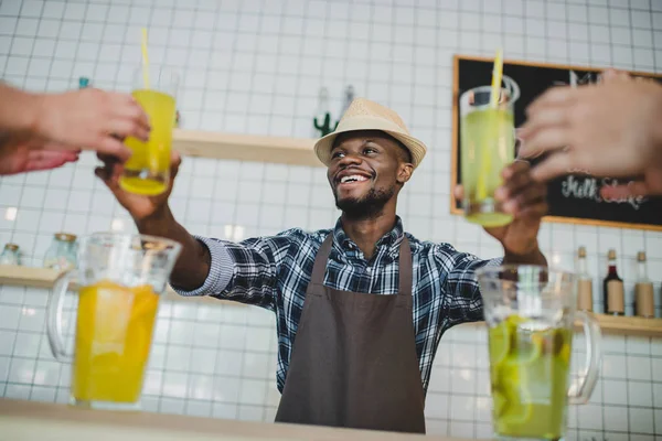 Barman afroamericano con limonadas - foto de stock