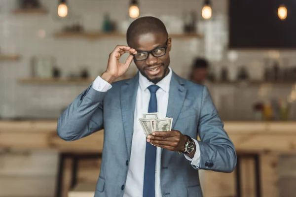 Hombre de negocios afroamericano con dinero - foto de stock