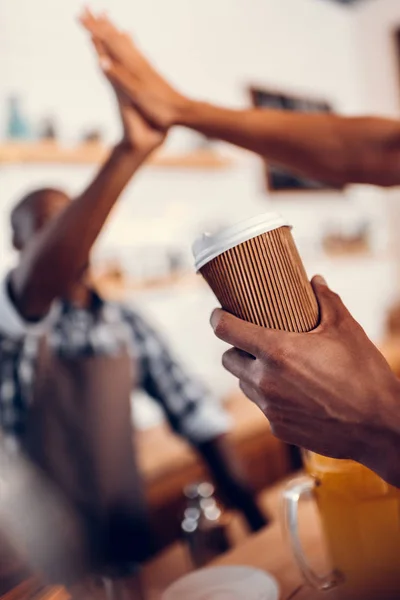 Barista giving highfive to client — Stock Photo
