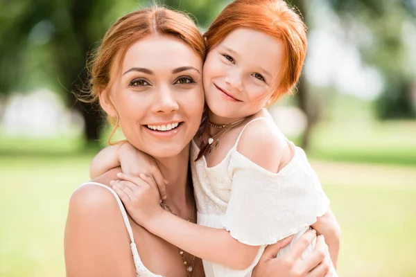 Mother and daughter hugging at park — Stock Photo