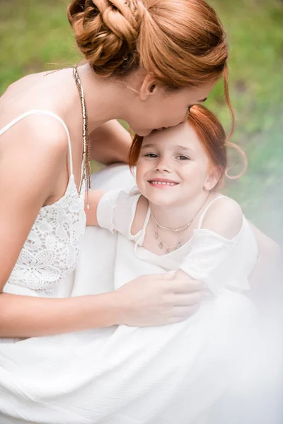 Mother kissing daughter — Stock Photo
