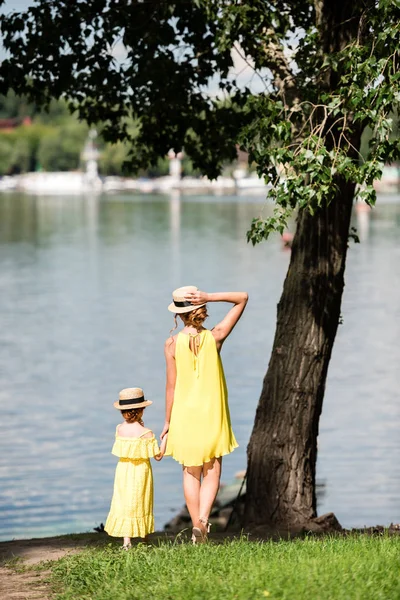 Мати і дочка гуляють на березі річки — стокове фото