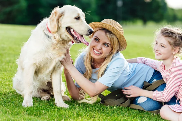 Mother and daughter with dog in park — Stock Photo
