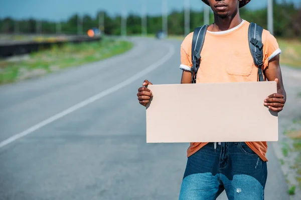 African american hitchhiker with empty cardboard — Stock Photo