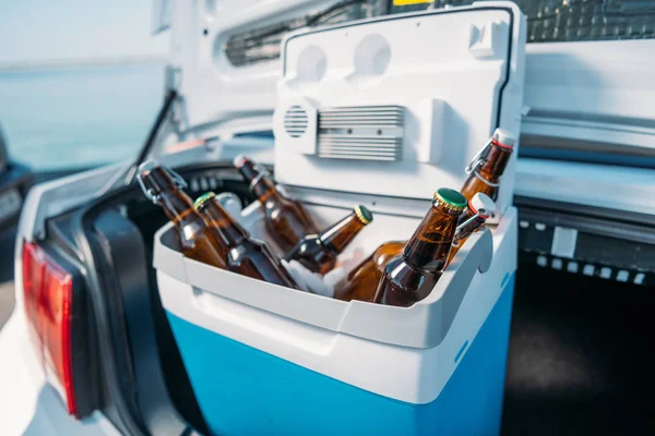 Portable fridge with beer in car — Stock Photo