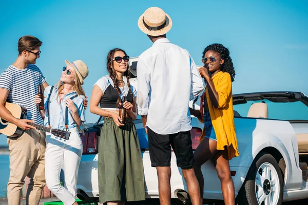 Multicultural friends spending time at seaside — Stock Photo