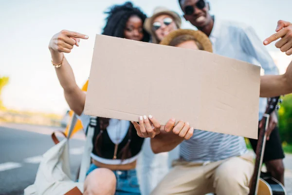 Multicultural friends hitchhiking together — Stock Photo