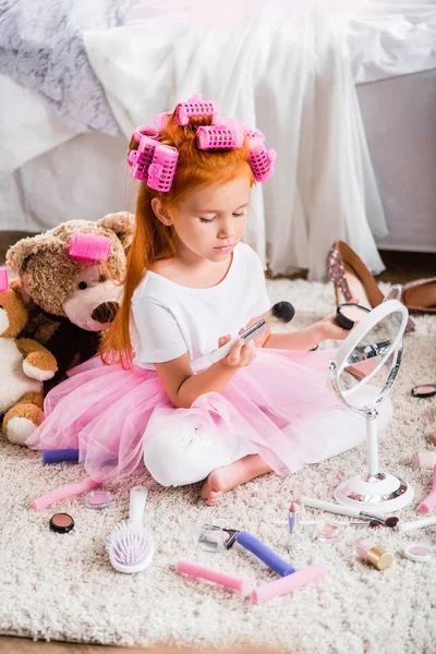 Little girl with face powder — Stock Photo