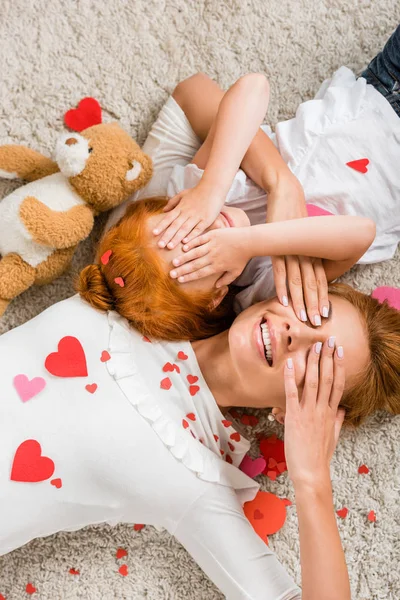 Mother and daughter with hearts and teddy bear — Stock Photo