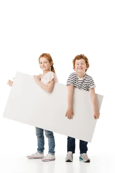 Pelirroja hermanos con carrito de compras - foto de stock