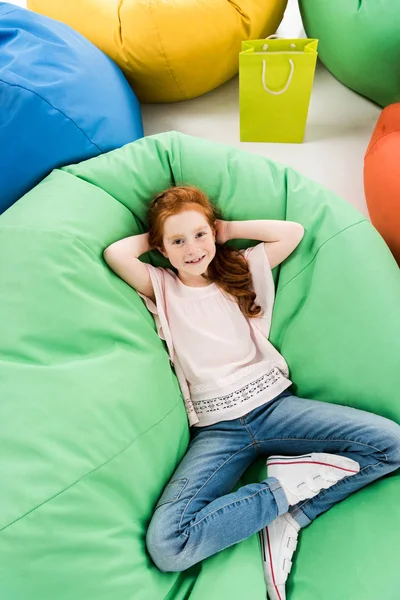 Child lying on bean bag chair — Stock Photo